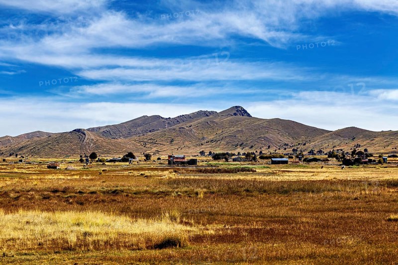Wide fields and hills under a clear blue sky, The Altiplano landscape in the Andes of Bolivia