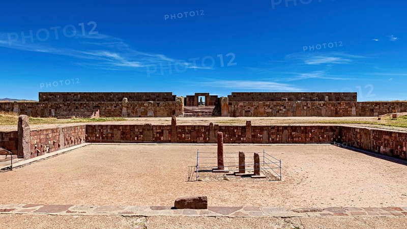 Open ruins with stone walls and sandy soil under a clear blue sky, The archaeological site with the ruins of Tiwanaku in Bolivia