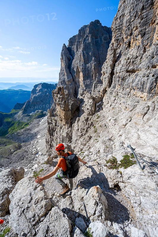 Climbers on the Via Ferrata Bocciere Centrale via ferrata, spectacular mountain landscape with steep cliffs and rock towers, Brenta Mountains, Parco Naturale Brenta-Adamello, Trentino, Italy