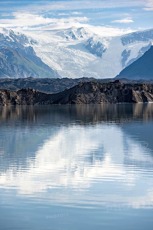 Mountain landscape reflected in glacial lake, Mount Blackburn and Kennicott Glacier, McCarthy Road, Wrangell St. Elias National Park, Alaska, USA