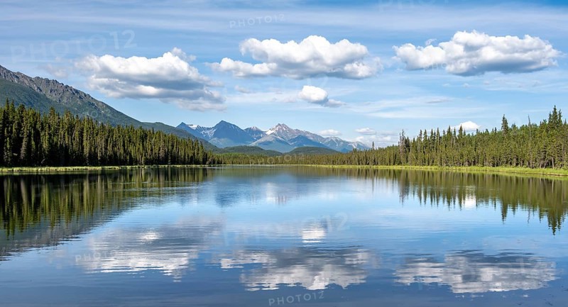 Mountains are reflected in idyllic Crystal Lake, McCarthy Highway, Wrangell St. Elias National Park, Alaska, USA