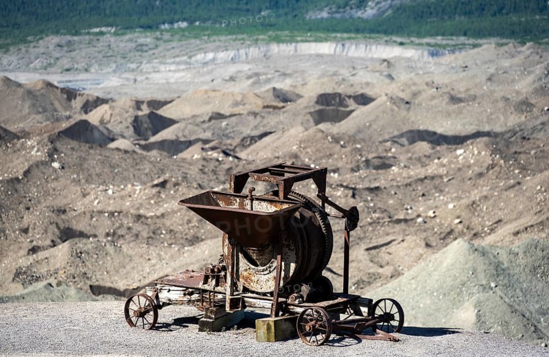 Old rusted moving mill for rock in front of mountain landscape with Kennicott Glacier, Historic Kennecott Copper Mine, National Historic Landmark, Wrangell St. Elias National Park, Alaska, USA