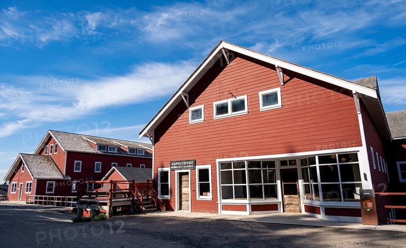 Red Kennicott buildings against mountainous landscape, Kennecott Post Office, Historic Kennecott Copper Mine, National Historic Landmark, Wrangell St. Elias National Park, Alaska, USA