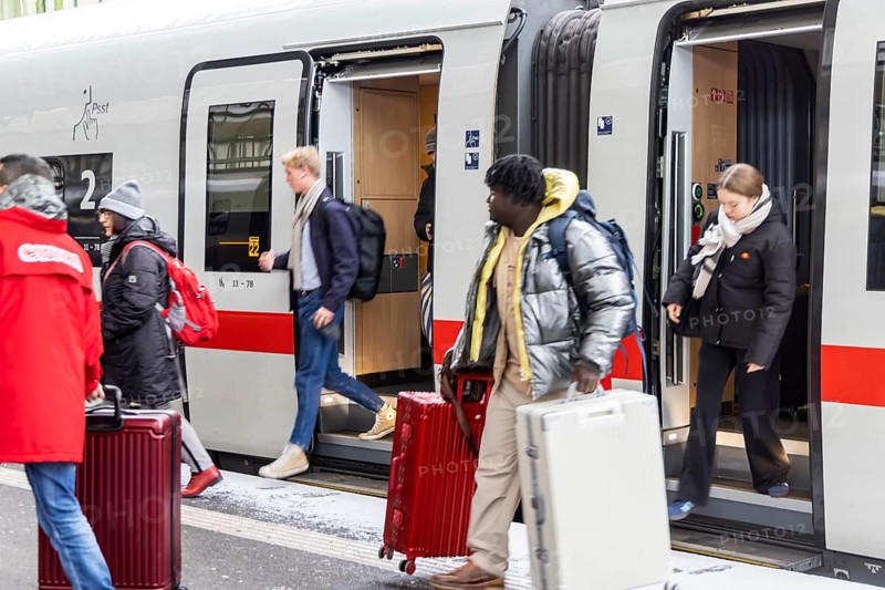 Winter in Stuttgart. There is also a closed layer of snow in the main train station. Travelers with suitcases disembarking from an ICE. Stuttgart, Baden-Württemberg, Germany