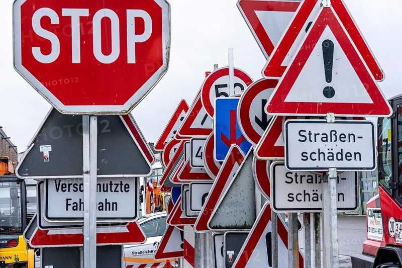 Storage for traffic signs in the yard of a road maintenance department, various signs with commandments and prohibitions, information about dangers, road traffic