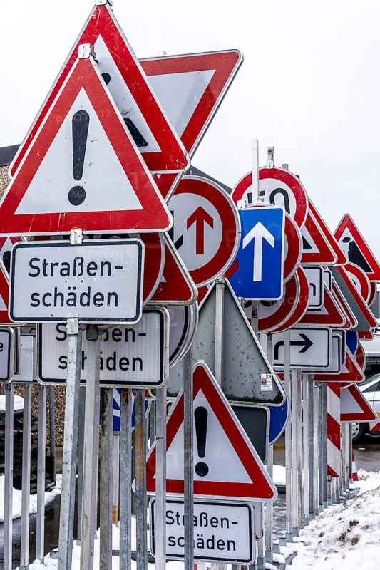 Storage for traffic signs in the yard of a road maintenance department, various signs with commandments and prohibitions, information about dangers, road traffic