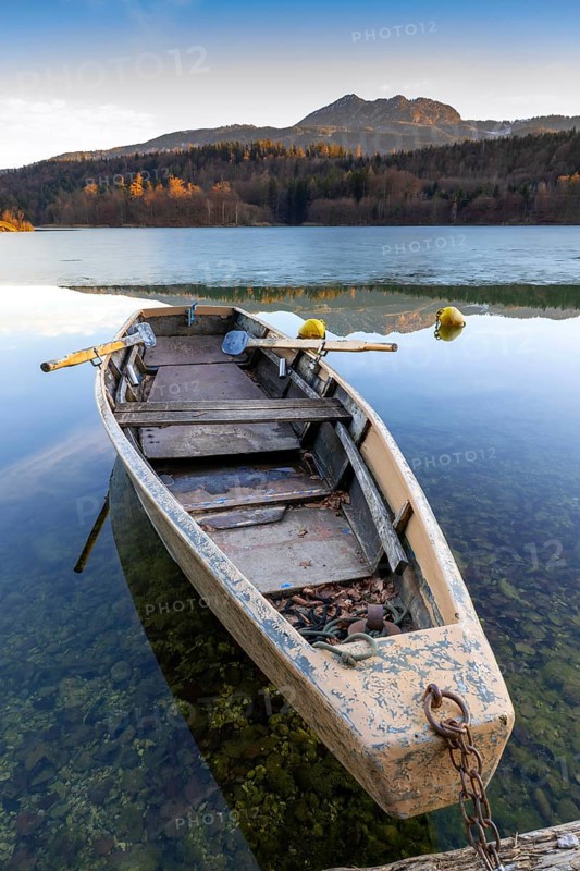 Wooden rowing boat on wintry Reintaler See, Reintaler See, Tyrol, Austria