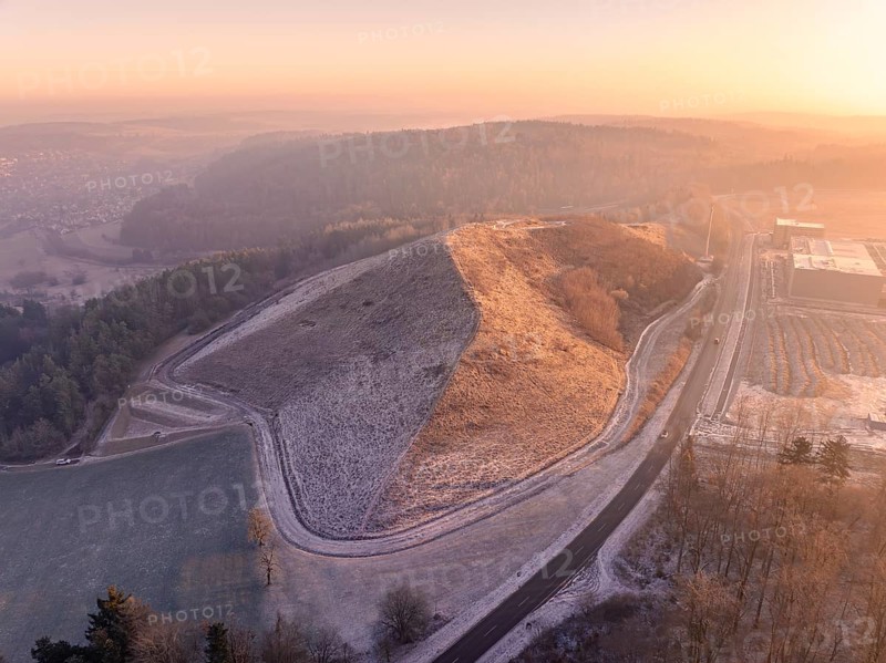 Hillside area at sunset with golden light and snowy paths, old deposit, construction site for PV open space system, Lindenrain, Calw, Germany