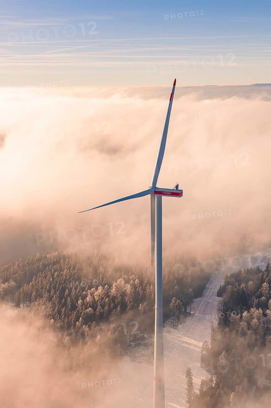 Large wind turbine in a foggy tree landscape, caught in a golden evening mood, Bad Wildbad, Calw district, Black Forest, Germany