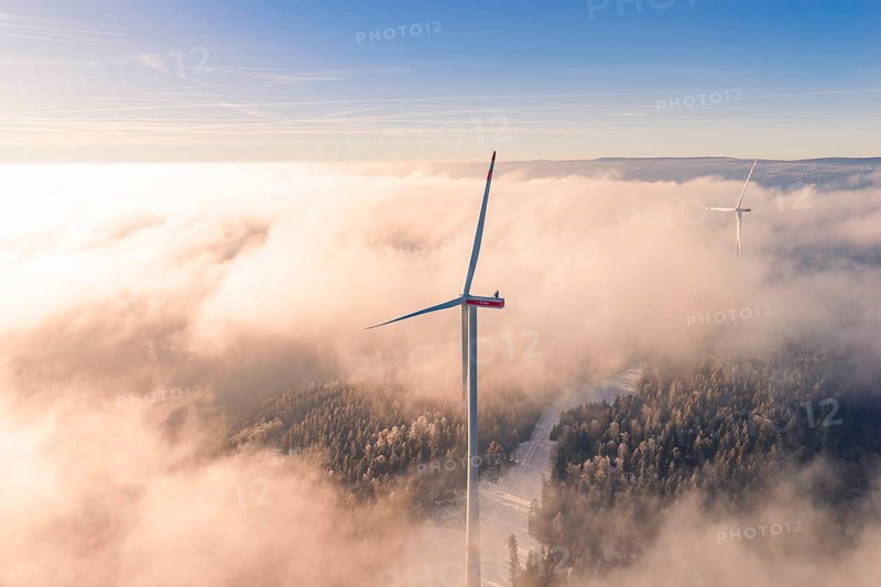 Wind turbine juts out of cloud cover, surrounded by foggy landscape at sunset, Bad Wildbad, Calw district, Black Forest, Germany