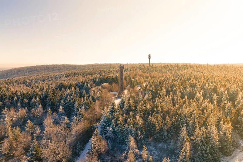 A wide view of a snow-covered forest with a tower on the horizon, Holohturm, Gernsbach, Rastatt district, Germany