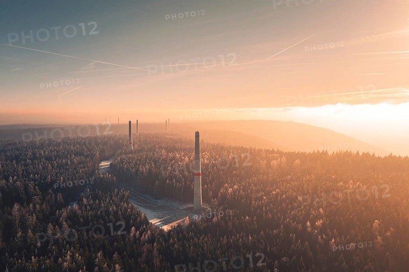 Dawn over a foggy forest with several wind turbine towers rising from the trees, Windkraft Bau, Besenfeld, Seewald, Freudenstadt district, Germany