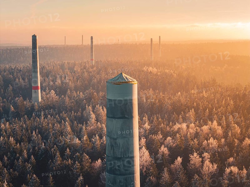Wind turbine towers stand in orange light in the morning over a forest surrounded by thick fog, a mood of vast peace, Windkraft Bau, Besenfeld, Seewald, Freudenstadt district, Germany
