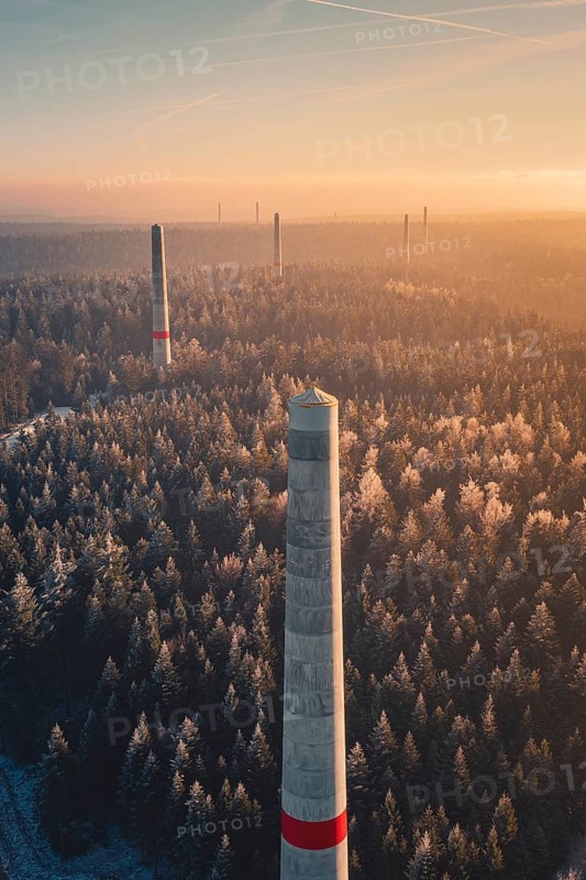 High wind turbine towers over frozen forest at sunrise, clouds of fog over the landscape, Windkraft Bau, Besenfeld, Seewald, Freudenstadt district, Germany