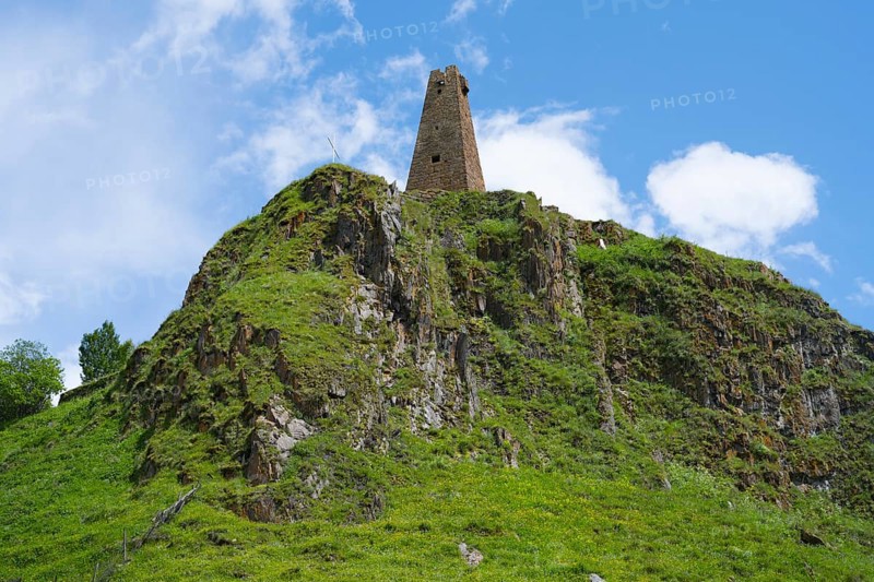 Historic tower ruin on a rocky hill under clear blue sky in nature, Zion Tower, Sioni, Georgian Military Road, Mtskheta-Mtianeti Province, High Caucasus, Georgia