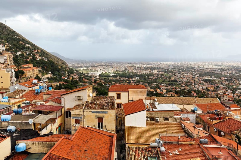 View of red tile roofs of the city of Monreale, Palermo on the horizon, Monreale, Sicily, southern Italy, Italy