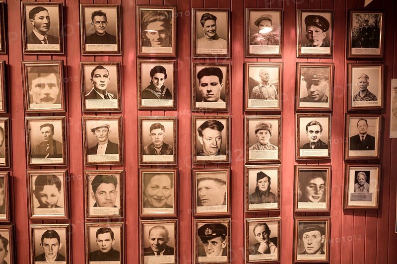 Gallery of portraits of Norwegian resistance fighters in the partisan museum in the old school of Kiberg on a wooden wall, Kiberg, Troms, Norway