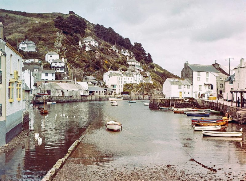 Historic waterfront buildings around the harbour river mouth of the River Pol at village of Polperro, Cornwall, England, UK