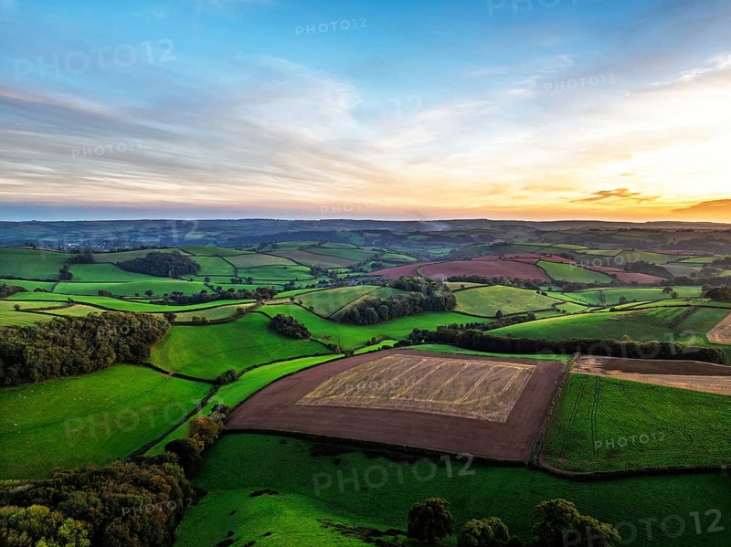 Sunset of Devon Farms and Fields over Berry Pomeroy from a drone, Totnes, England, United Kingdom