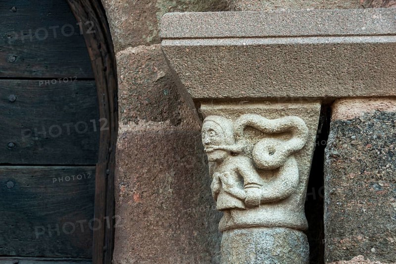 Sculptural details on the porch of the Romanesque church in Azerat village, Haute Loire, Auvergne-Rhone-Alpes, France