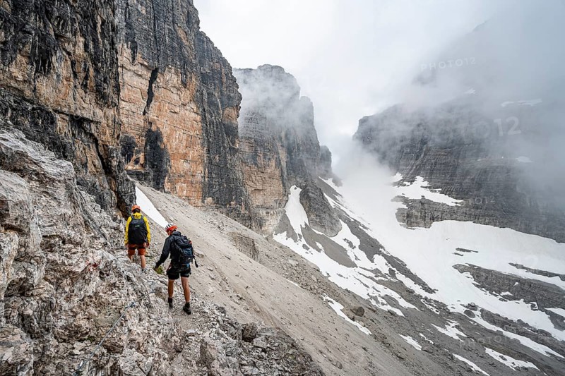 Two mountaineers descending to Rifugio Alimonta, Brenta Mountains, Trentino, Italy