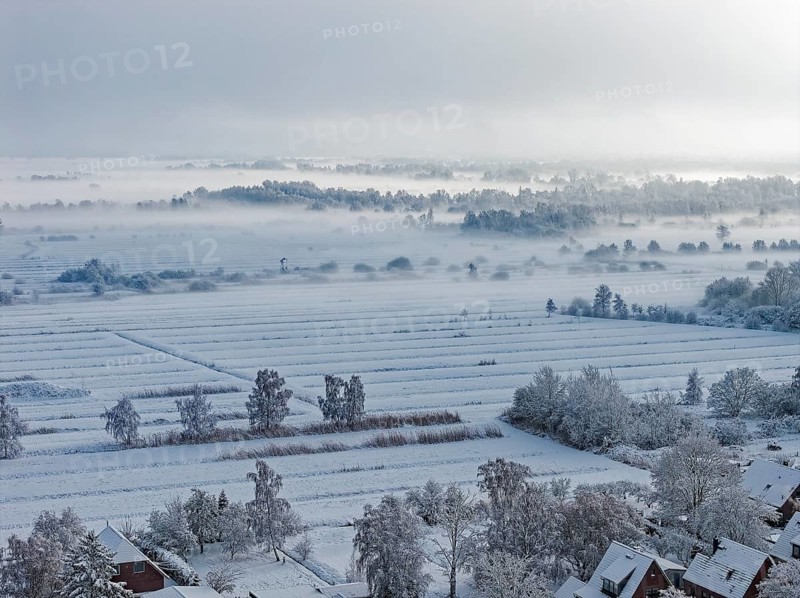 The onset of winter with snow and ground fog in Hamburg's Kirchwerder Wiesen Nature Reserve in the Vier- and Marschlanden. aerial view. Kirchwerder, Hamburg, Germany