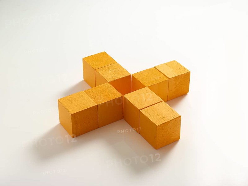 8 yellow wooden cubes against a white background