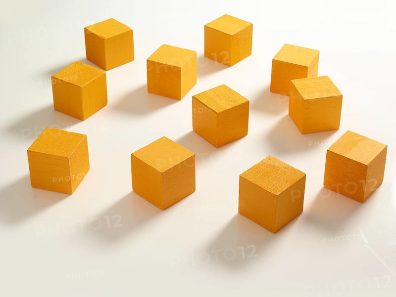 11 yellow wooden cubes against a white background