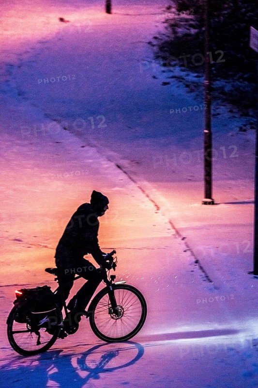Winter weather, blowing snow, person with e-bike, bicycle on snowy road, North Rhine-Westphalia, Germany