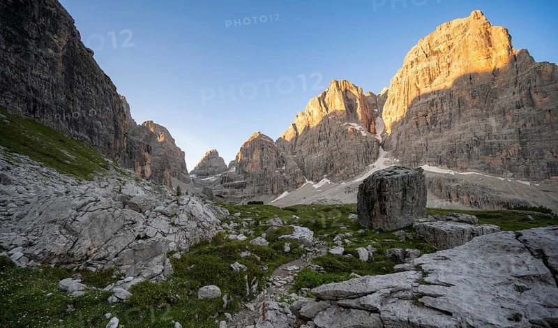 Picturesque mountain landscape in Val Brenta Alta at sunrise, rocky peaks of Cima Tosa, Alpenglühen, Brenta, Trentino, Italy