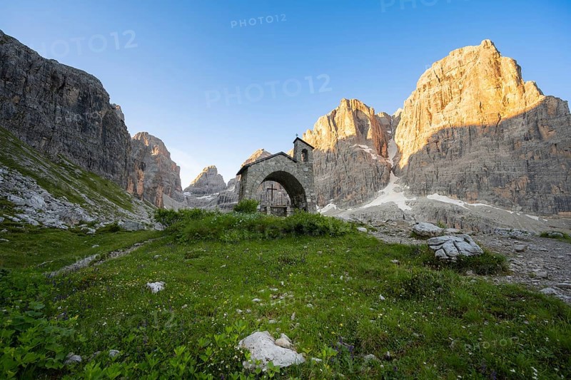 Cappella Ai Brentei chapel Memorial for injured mountaineers at the Rifugio Ai Brentei mountain hut, rocky peaks at sunrise with alpine glow, picturesque mountain landscape, Brenta, Trentino, Italy