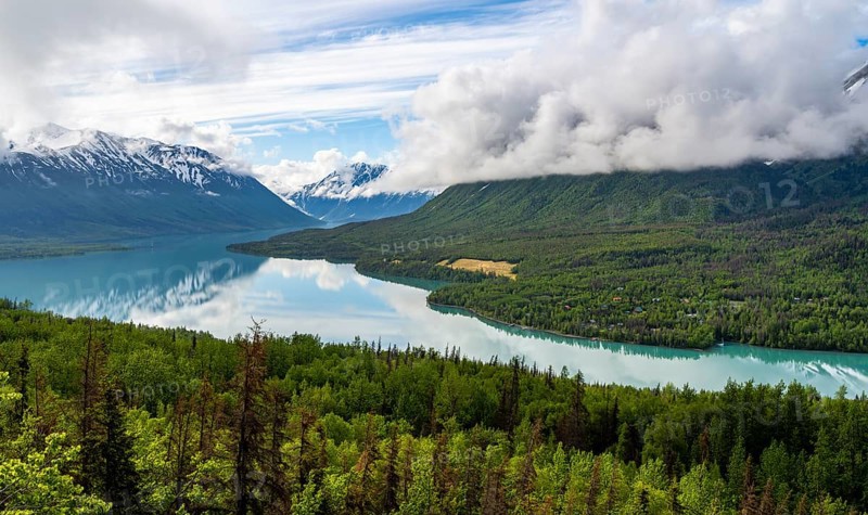 View of snowy mountains in spring and turquoise blue Kenai Lake, Slaughter Ridge Trail, Cooper Landing, Kenai Peninsula, Alaska, USA