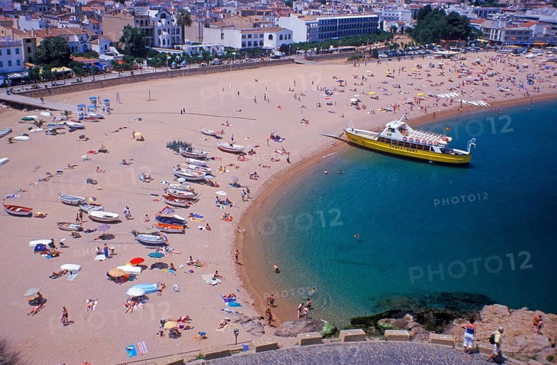 Houses, people, sightseeing boat on Tossa de Mar beach, Costa Brava, Spain, June 1999, vintage, retro, old, historic