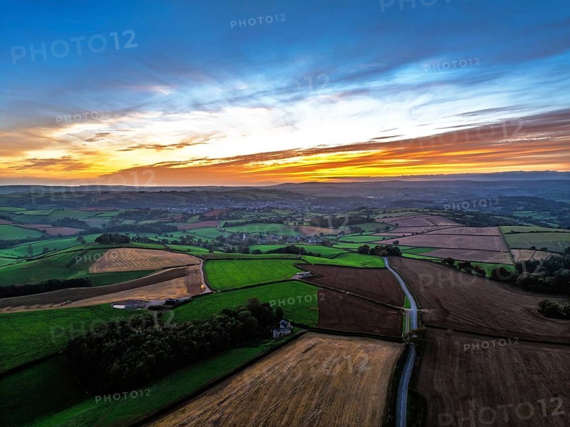 Sunset of Devon Farms and Fields over Berry Pomeroy from a drone, Totnes, England, United Kingdom
