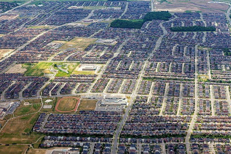 A densely built residential area with a clearly recognizable street pattern seen from the air, view from an airplane of the suburbs of Toronto in Canada