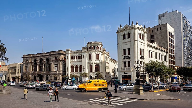 Distinctive historic buildings at a busy crossroads under blue skies, Downtown Lima in Peru