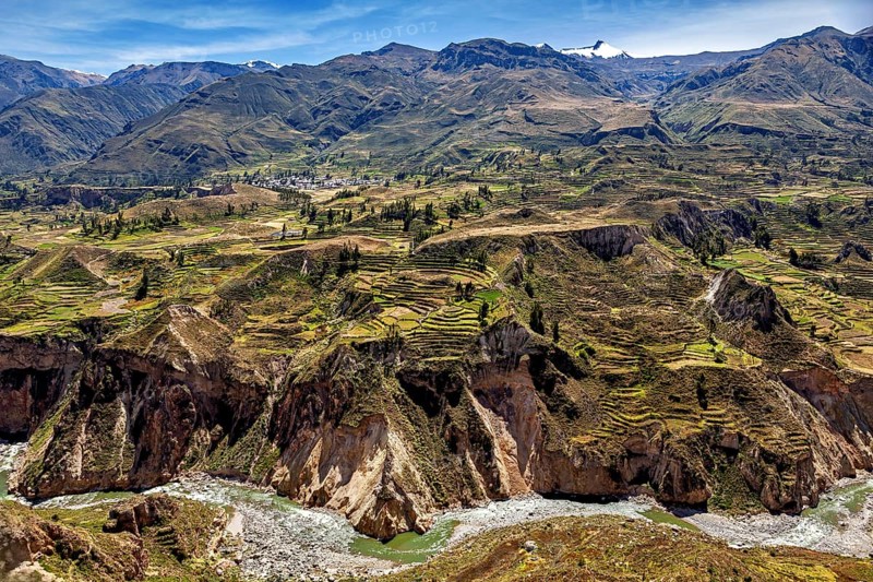 Mountain landscape with many terraces and a river under clear sky, The landscape of the Colca Canyon in the Andes of Peru