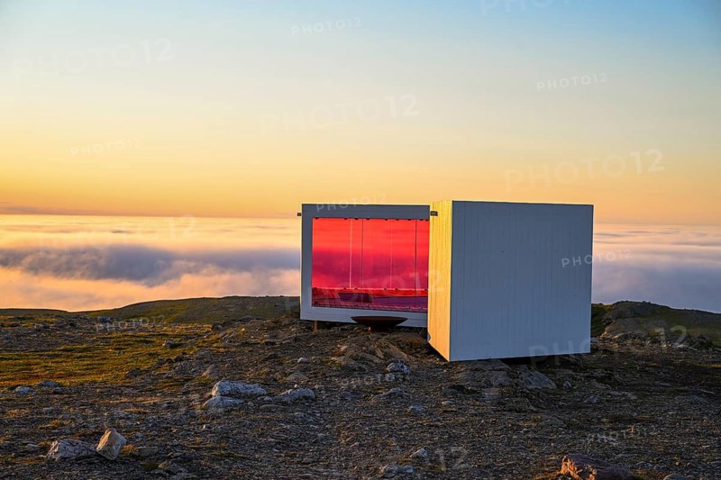 Windbreaks and observation huts on Mount Domen. The project consists of three small buildings, which are arranged in such a way that they always protect against wind and weather, and the reddish color protects birds from impact. Biotope Architectural Office. Domen, Vardö, Finnmark, Norway
