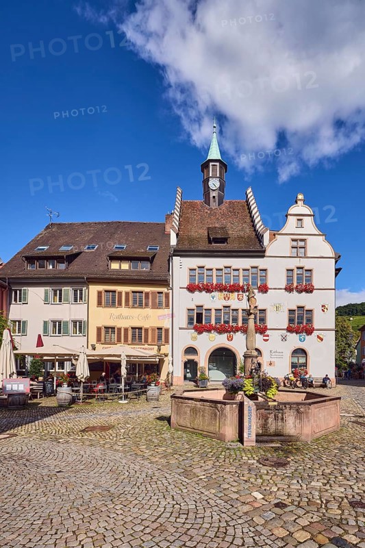 Historic town hall, market fountain, general architecture, historic buildings, houses, town hall café, cobblestone square, blue sky, cumulus clouds, intersection of main street with Kirchstraße, Staufen im Breisgau, Black Forest, Breisgau-Hochschwarzwald district, Baden-Württemberg, Germany