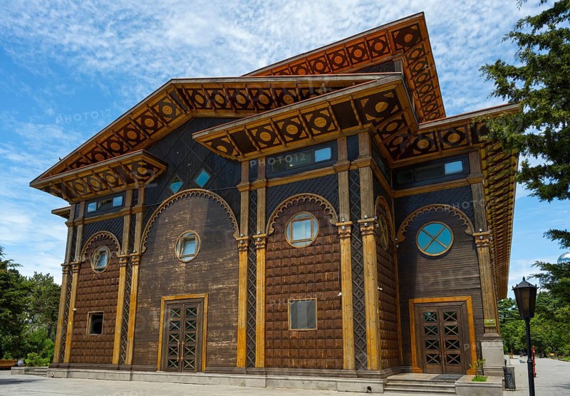 A distinctive wooden building with artistic decorations against a tranquil backdrop, Summer Theatre, Batumi, Black Sea, Ajara region, Adjara, Autonomous Republic, Georgia