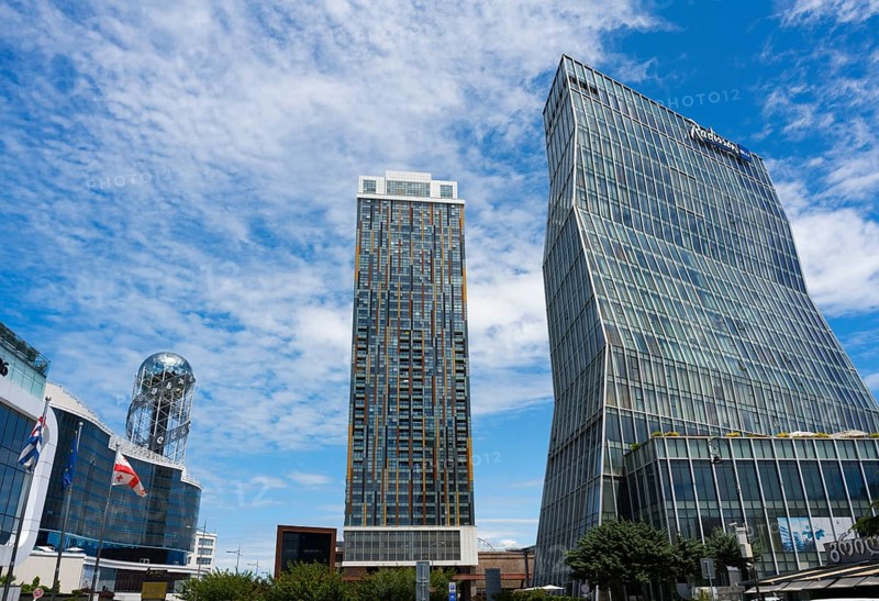 Two modern high-rise buildings with glass facades under cloudy sky, Radison Blue on the right and Alphabetic Tower, Georgian Alphabet Tower, Batumi, Black Sea, Adjara region, Adjara, autonomous republic, Georgia
