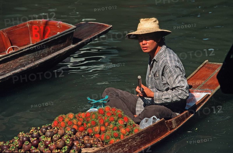 Merchant in his boat at Damnoen Saduak Floating Market, Thailand, December 2002, vintage, retro, old, historic