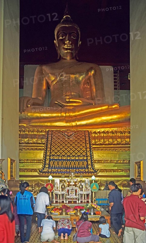 People praying in the temple with the Buddha statue Phra Mongkhonbophit, Ayutthaya, Thailand, December 2002, vintage, retro, old, historic