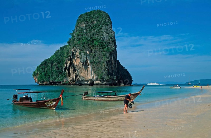 Rocks in the sea, people and longtail boats on Pranang Cave beach, two years in front of the tsunami, Krabi, Thailand, December 2002, vintage, retro, old, historic