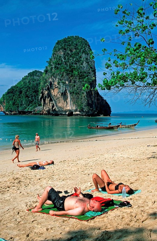 Rocks in the sea, people and longtail boats on Pranang Cave beach, two years in front of the tsunami, Krabi, Thailand, December 2002, vintage, retro, old, historic