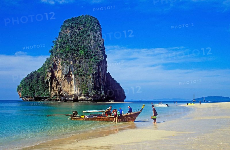 Rocks in the sea, people and longtail boat on Pranang Cave beach, two years in front of the tsunami, Krabi, Thailand, December 2002, vintage, retro, old, historic