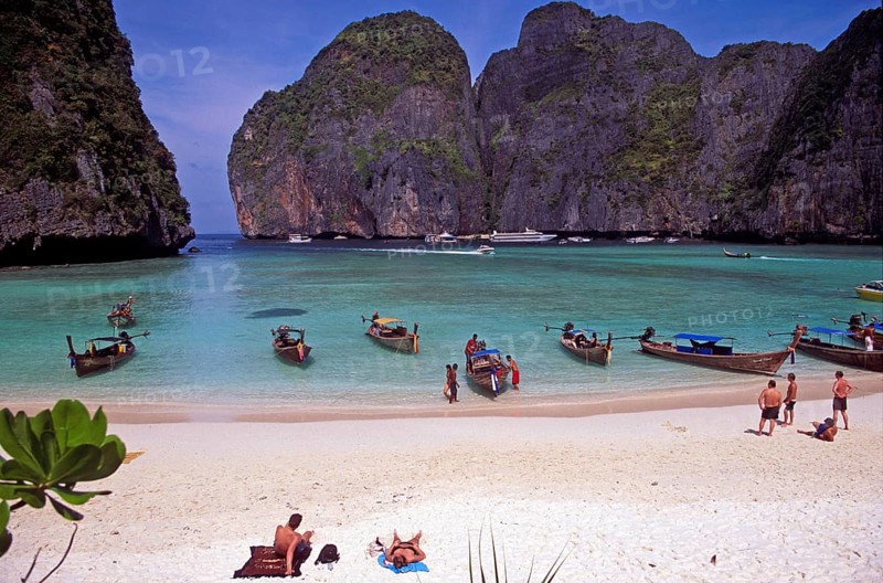 People, longtail boats on Maya Bay beach, known from the movie The Beach, one year in front of the tsunami, Ko Phi Phi Le, Thailand, December 2002, vintage, retro, old, historic
