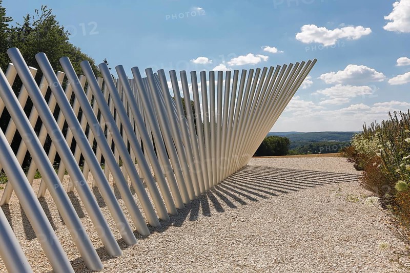 Art in public space, sculpture made of aluminum profile pipes by artist Martin Burchard, life's horizon path near Mundingen, light and shadow, gravel, clouds, blue sky, walk-in art, paths of reflection and refreshment on the Ehinger Alb, Baden-Württemberg, Germany