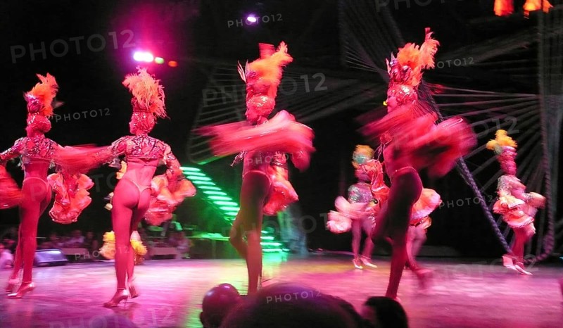 Revue dancers in opulent colorful costume and with feather headdress at Club Tropicana, Havana, Havana, Cuba