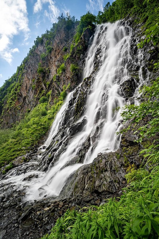 Horsetail Falls waterfall on the Lowe River in a green gorge, long exposure, Keystone Canyon, Richardson Highway, Alaska, USA